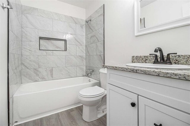 1781 Jajef Ave, Conley, GA 30288 - bathroom with wood finished floors, toilet, vanity, and bathing tub / shower combination