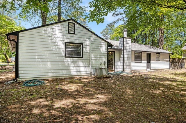 1781 Jajef Ave, Conley, GA 30288 - rear view of property featuring a chimney, central AC unit, and fence