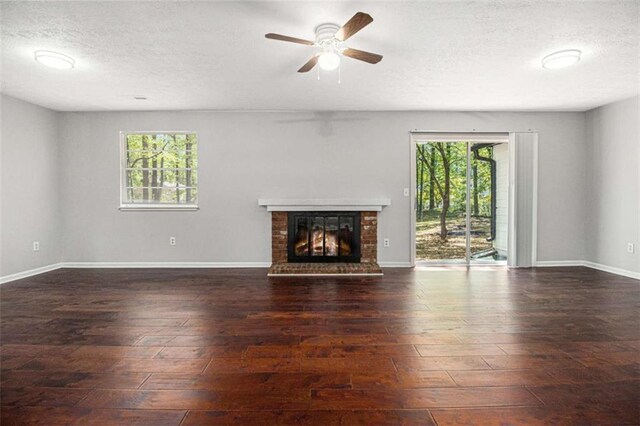 1781 Jajef Ave, Conley, GA 30288 - unfurnished living room featuring a fireplace, hardwood / wood-style floors, a textured ceiling, and a ceiling fan