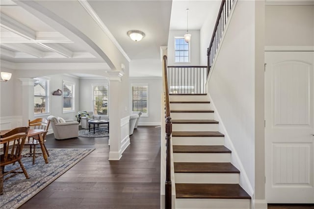 3610 Ansley Manor Ct, Cumming, GA 30028 - stairs with ornate columns, healthy amount of natural light, arched walkways, wood finished floors, and beamed ceiling