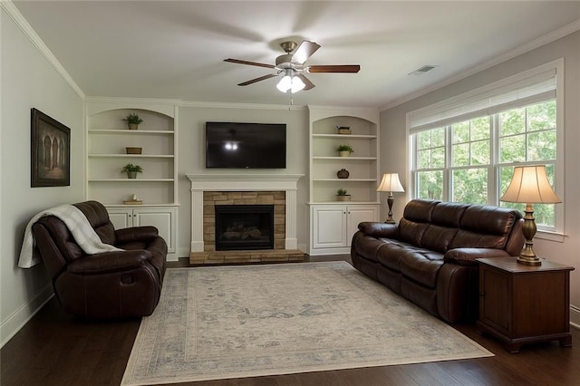3610 Ansley Manor Ct, Cumming, GA 30028 - living room featuring baseboards, built in features, ceiling fan, dark wood-type flooring, and crown molding