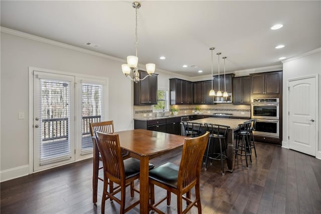3610 Ansley Manor Ct, Cumming, GA 30028 - dining area with ornamental molding, a chandelier, dark wood-style floors, recessed lighting, and baseboards