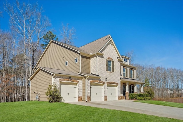 view of front of home featuring an attached garage, brick siding, concrete driveway, and a front yard