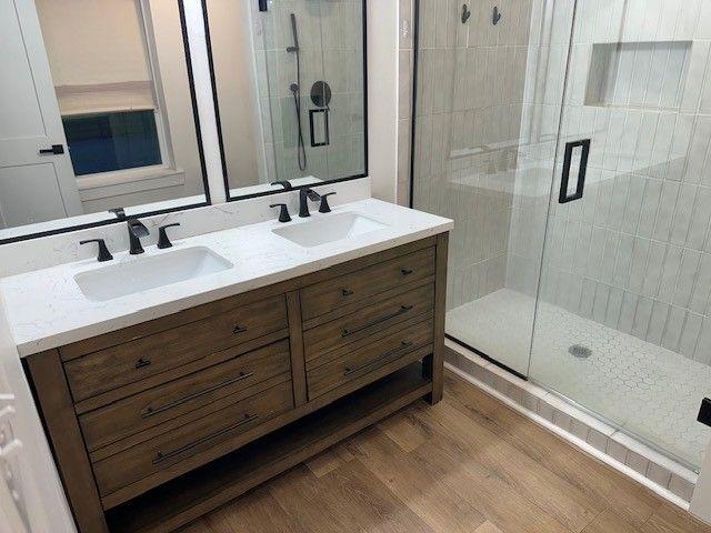 1360 Bethany Ct, Alpharetta, GA 30004 - full bath with a stall shower, double vanity, and wood finished floors