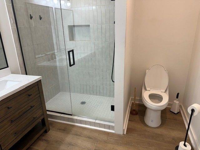 1360 Bethany Ct, Alpharetta, GA 30004 - full bath featuring a shower stall, vanity, and wood finished floors