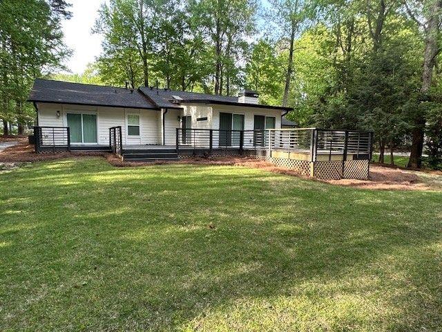 1360 Bethany Ct, Alpharetta, GA 30004 - back of house featuring a wooden deck, a lawn, and a chimney
