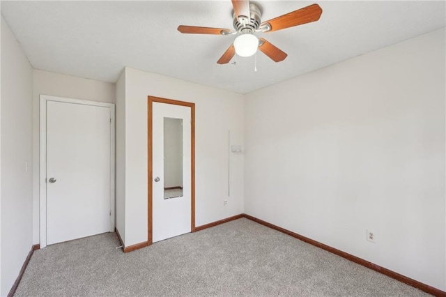 unfurnished bedroom featuring carpet flooring, baseboards, and ceiling fan