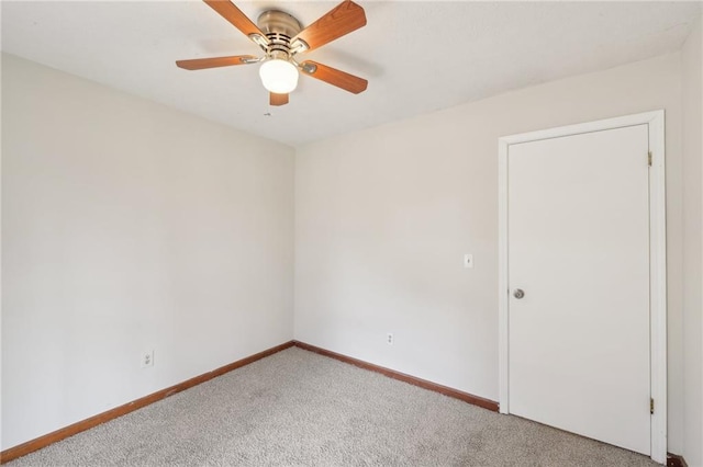 unfurnished room with baseboards, light carpet, and ceiling fan