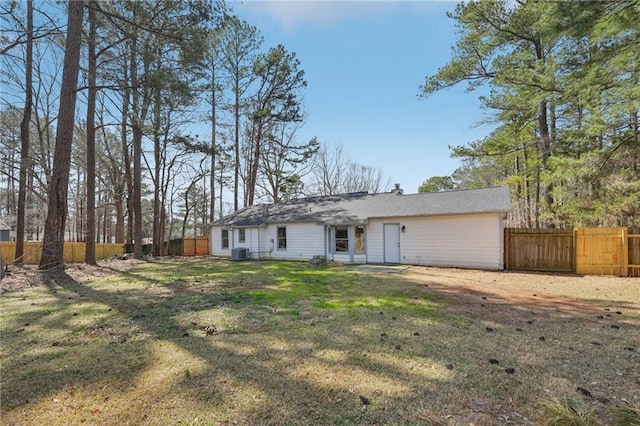 ranch-style home with central AC, a front yard, and fence