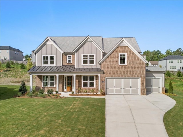 view of front of home with a garage, a porch, and a front lawn