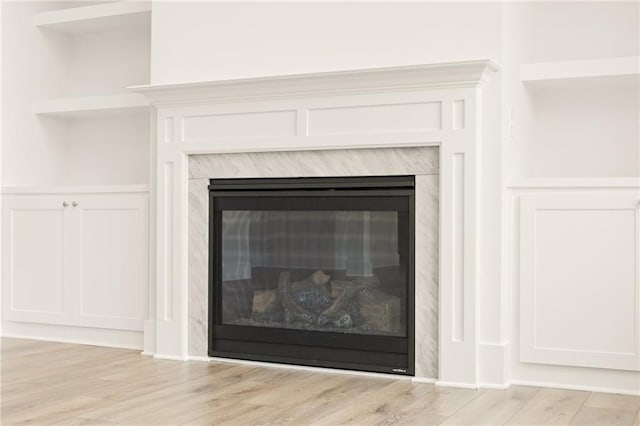 details featuring hardwood / wood-style floors and a fireplace