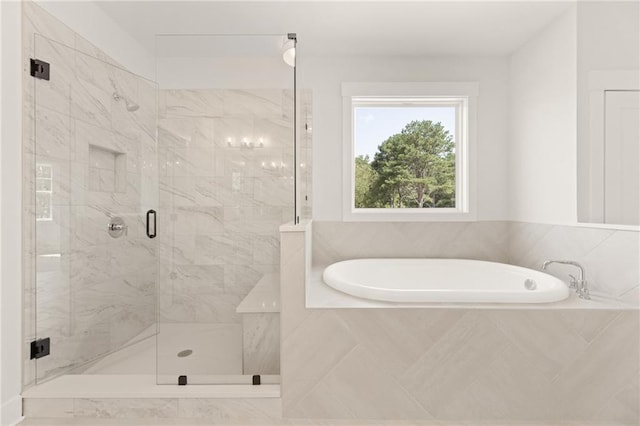 bathroom featuring shower with separate bathtub