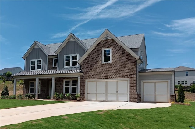 view of front of property featuring a front yard and a garage