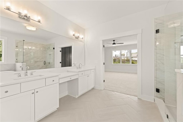 bathroom featuring vanity, ceiling fan, and a shower with door