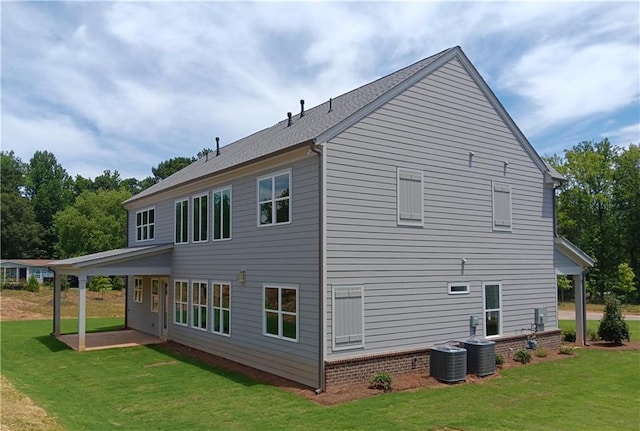 rear view of house with central air condition unit, a yard, and a patio area