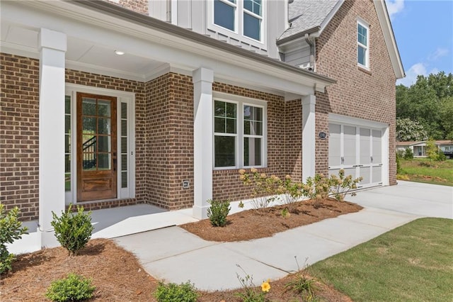 doorway to property with a garage and covered porch