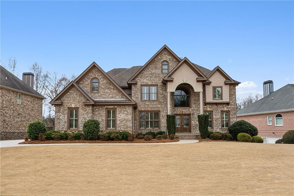 view of front of property with french doors and brick siding