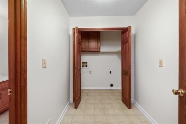 laundry area featuring baseboards, washer hookup, a textured ceiling, and hookup for an electric dryer