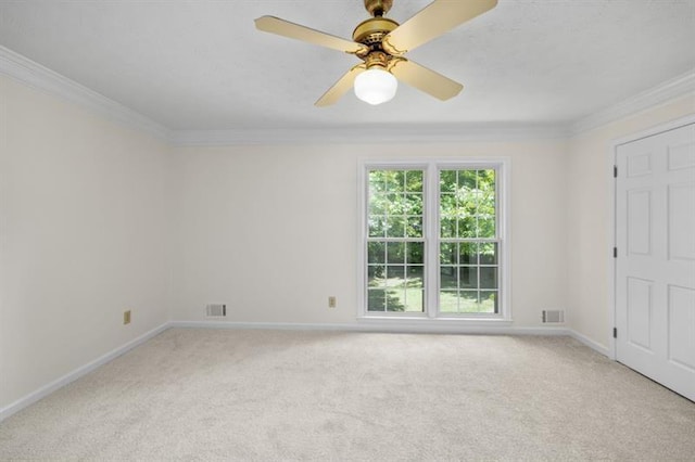 unfurnished room featuring ornamental molding, light colored carpet, and baseboards