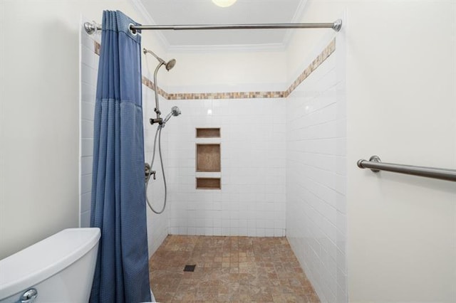 bathroom featuring a stall shower, crown molding, and toilet