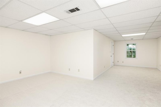 interior space featuring light carpet, a paneled ceiling, visible vents, and baseboards