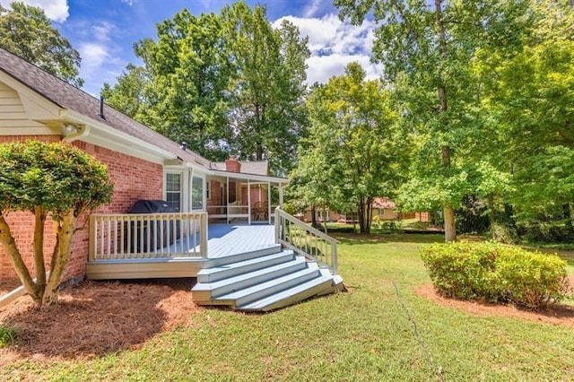 view of yard with a sunroom, fence, and a wooden deck