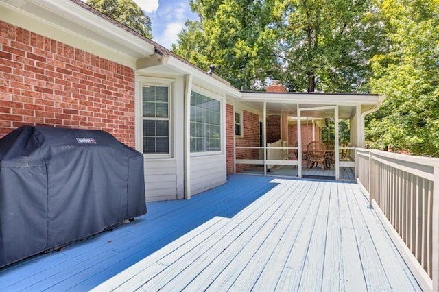 wooden terrace featuring a grill