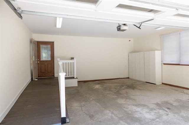 garage with baseboards and a garage door opener