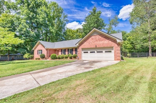 single story home with driveway, an attached garage, fence, a front yard, and brick siding