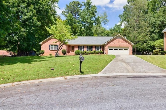 ranch-style home with a garage, a front yard, brick siding, and driveway