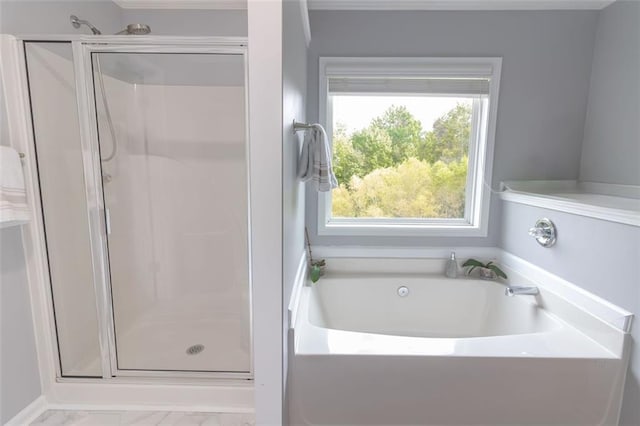 bathroom featuring separate shower and tub