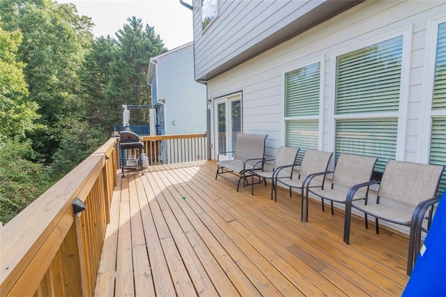 wooden terrace featuring area for grilling