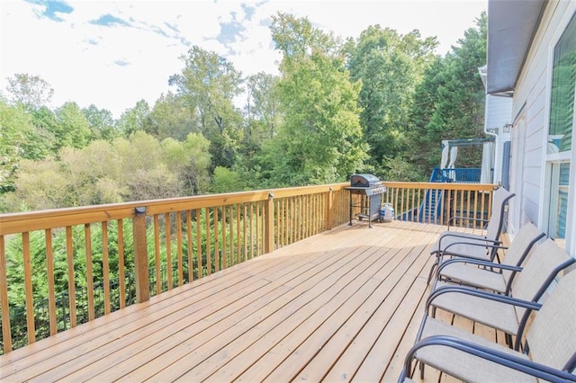 wooden terrace with a grill