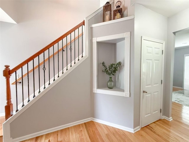 stairway with hardwood / wood-style flooring