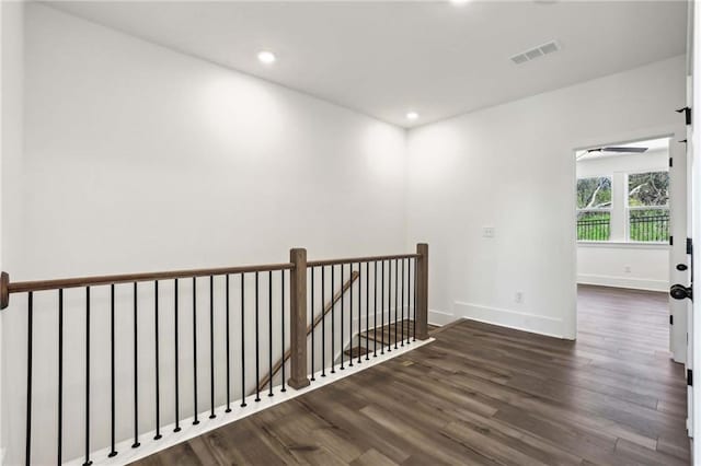 empty room featuring recessed lighting, visible vents, baseboards, and wood finished floors