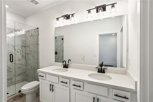 bathroom featuring visible vents, a marble finish shower, and a sink