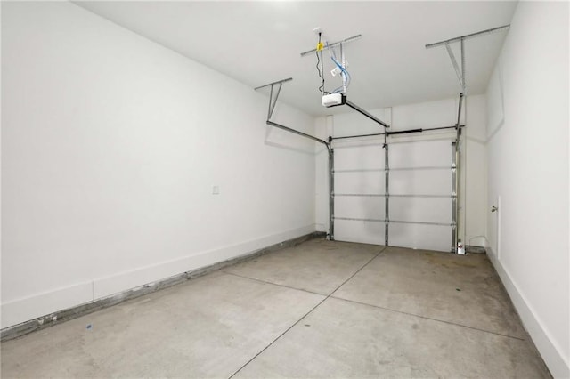 garage with a garage door opener and baseboards