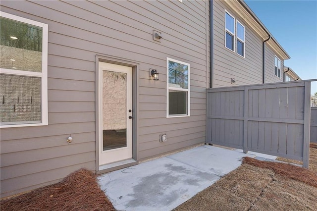 entrance to property with a patio and fence