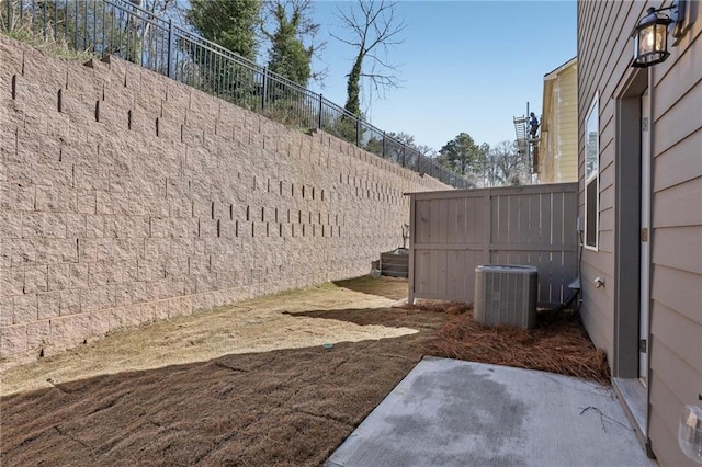 view of yard featuring cooling unit and fence