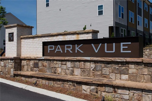 community sign with an attached garage