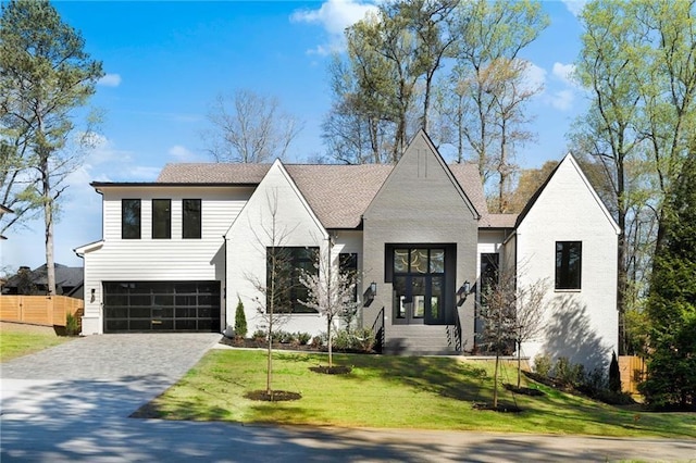 view of front of house featuring a garage and a front lawn