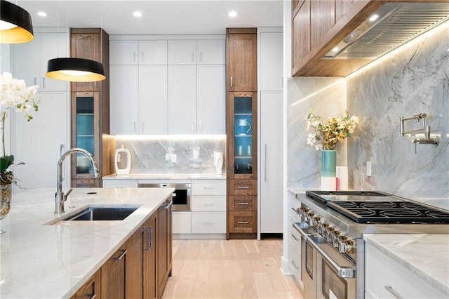 kitchen featuring appliances with stainless steel finishes, sink, decorative backsplash, and white cabinetry