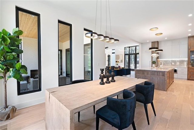 dining room with light hardwood / wood-style flooring and sink