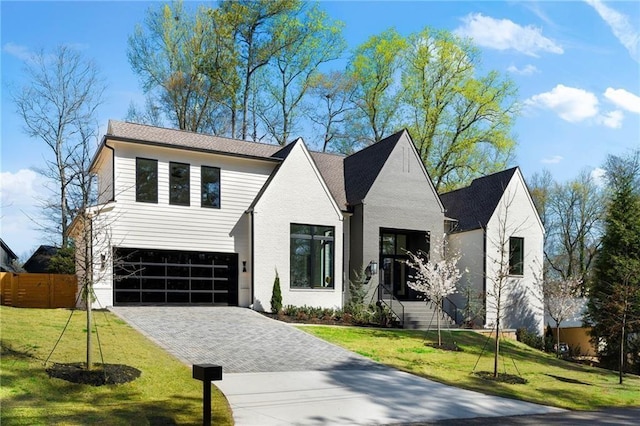 view of front of house featuring a garage and a front yard