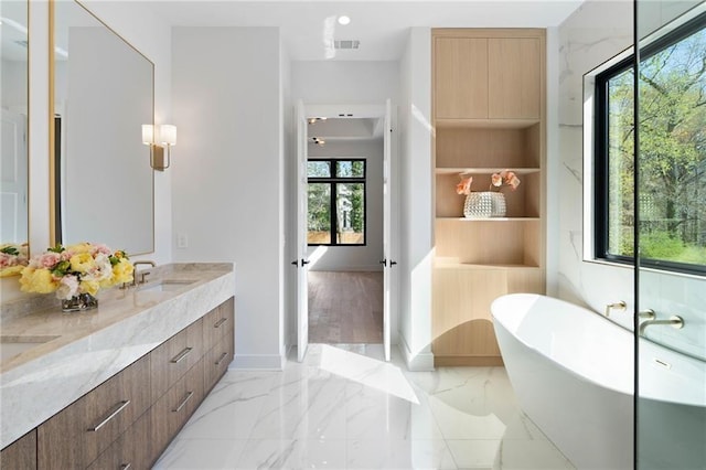 bathroom with a bath and vanity