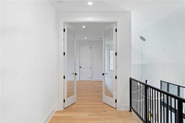 corridor with light wood-type flooring