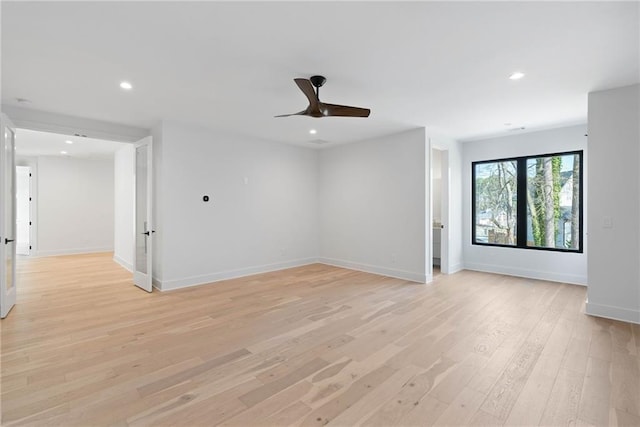 unfurnished room with ceiling fan and light wood-type flooring