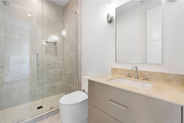 bathroom with vanity, a shower with shower door, and toilet