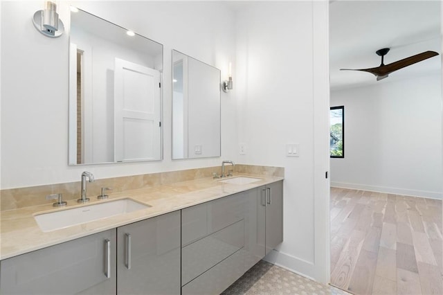 bathroom with wood-type flooring, vanity, and ceiling fan