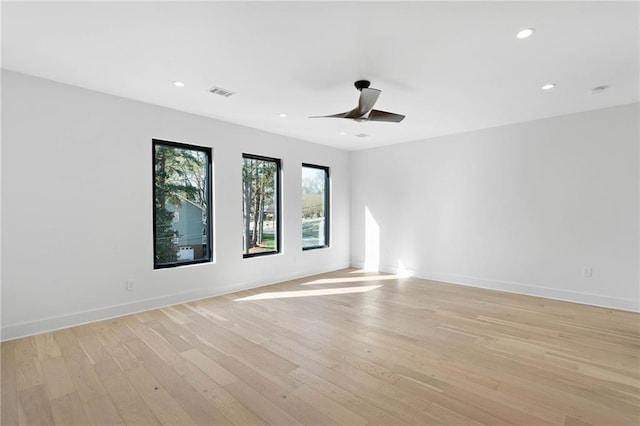 empty room featuring ceiling fan and light hardwood / wood-style flooring